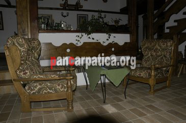 Imagine living cu scaune, mese din lemn si mobila moderna in pensiunea Sonet de Munte din Sucevita