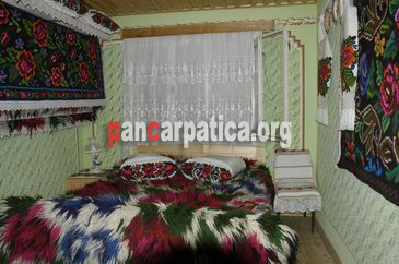 Imagine a camerei cu pat dublu din cadrul pensiunii Sub Cetate la Matei cu interior decorat cu gust