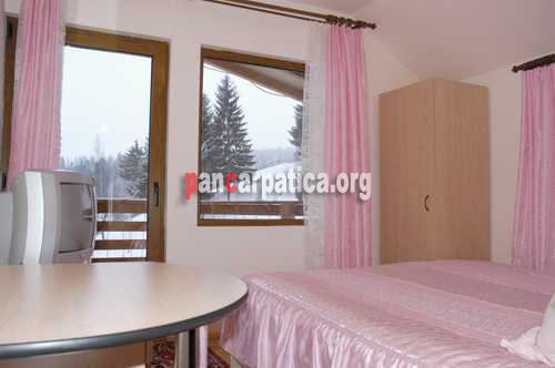 Imagine camera cu pat matrimonial la pensiunea Eladi cu balcon mare ce da spre zona muntilor din imprejurimile localitatii Borsa